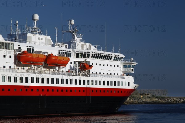 Hurtigruten ship on open sea against blue sky and calm water surface near Svolvær, Svolvær, Nordland, Norway