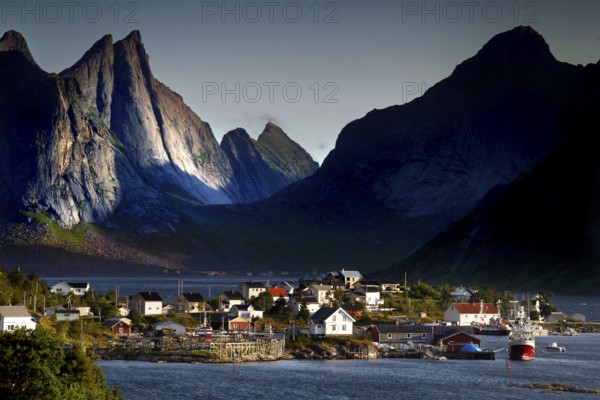 Picturesque harbour village with steep mountain peaks as a backdrop, Hamnøy, Moskenesøy, Norway