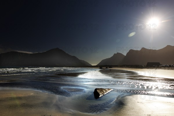Sunny beach on Flakstadøy with mountains in the background, Flakstad, Lofoten, Norway