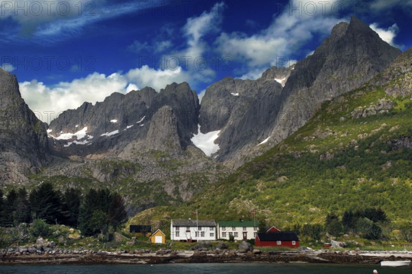 Impressive mountain landscape of Lofoten at Raftsund with distinctive mountain peaks and slightly cloudy sky, Lofoten, Nordland, Norway