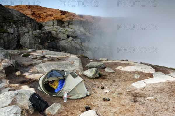 Tent on rocky terrain with fog, near Kjerag, Lysefjord, Rogaland, Norway