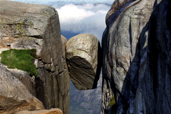 The Kjeragbolten is impressively enthroned between two majestic rock faces, Kjerag, Rogaland, Norway