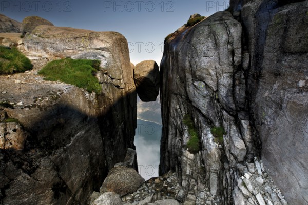 Spectacular view of Kjeragbolten nestled between steep rocks, Kjerag, Rogaland, Norway