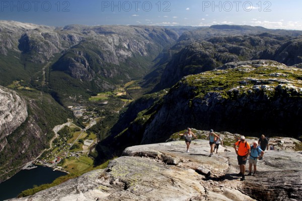 Hikers enjoy spectacular views while climbing Kjerag, Lysefjord, Rogaland, Norway