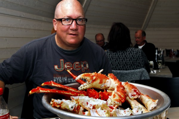 Person sitting in front of a large plate of king crab in Sarnes, Sarnes, Norway