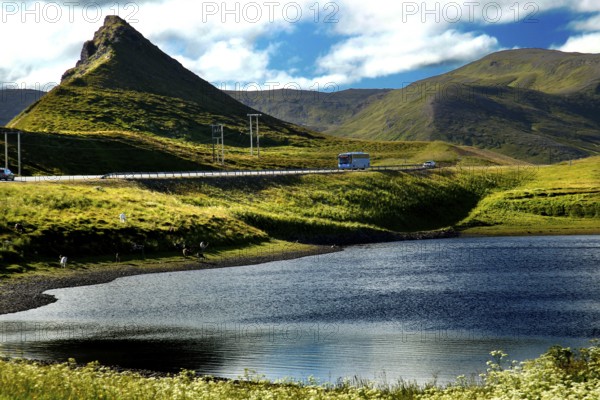 Spectacular landscape with mountain, lake and green fields under blue sky, N Sarnes, null