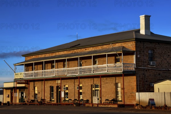 Historic Marree Hotel with impressive veranda and clear blue sky, Marree, South Australia, Australia