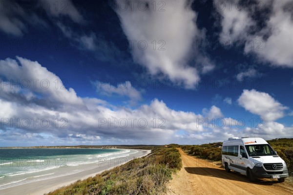 A campervan is parked on a sandy road along a picturesque coast, Vivonne Bay, Kangaroo Island, Australia