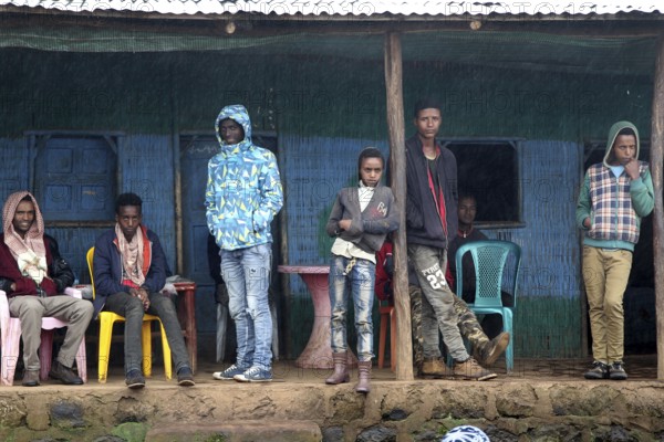 People in front of simple building in Rira, Bale Mountains, cool atmosphere, Rira, Bale Mountains, Ethiopia