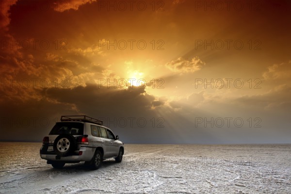 Landcruiser under impressive sunrise in the desert, Dallol, Asale, Ethiopia