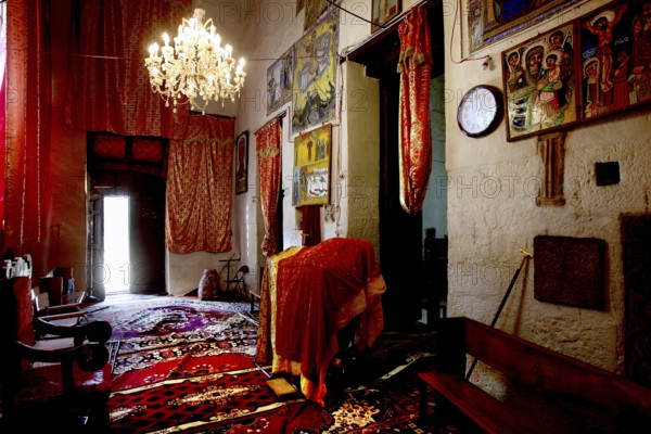 Rich interior of St. Mary's Cathedral in Axum with murals and chandeliers, Axum, Ethiopia