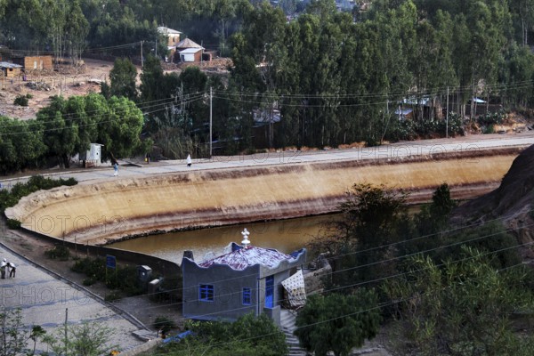 Historic view of Queen of Sheba's pond with lush green surroundings in Axum, Axum, Ethiopia