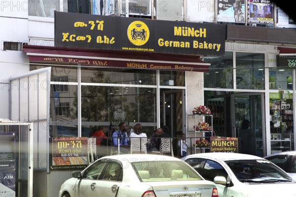 Modern German cafe in an urban setting in Addis Ababa, with cars in the foreground, Addis Ababa, null, Ethiopia