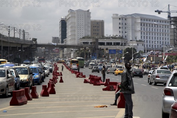 Dense traffic road with modern buildings in the background, Addis Ababa, Ethiopia