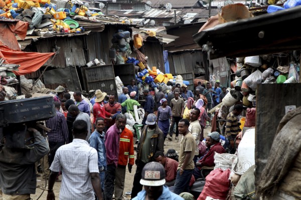 Large crowds of people on the busy Mercato in Addis Ababa, surrounded by colorful fabrics, Addis Ababa, Ethiopia