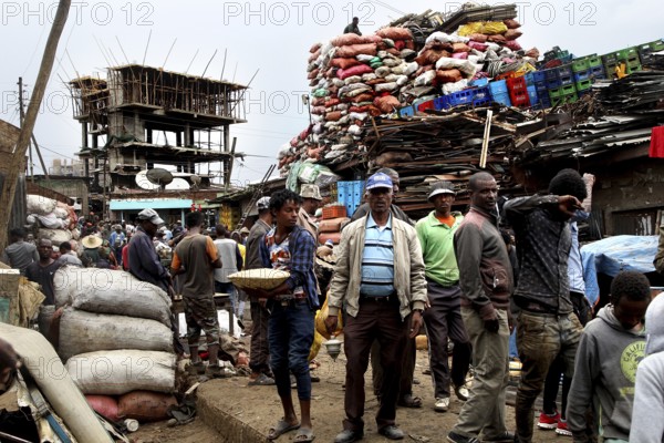 Merchants sell goods amid huge bales of fabric on the busy Mercato in Addis Ababa, Addis Ababa, Ethiopia