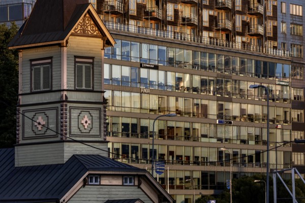 Wooden church in front of a modern glass façade in the Rotermann quarter, reflective architecture with urban flair, Tallinn, Harju, Estonia