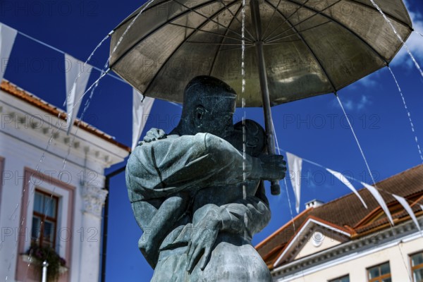 Close-up view of the sculpture of students kissing with umbrella, a landmark of Tartu, against the clear sky, Tartu, Estonia