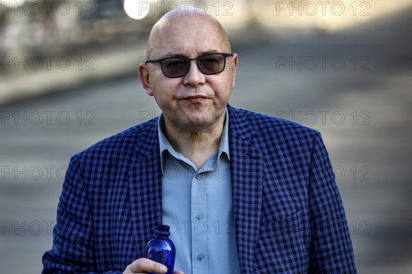 Man wearing checkered suit and sunglasses walks on the street in Tallinn, Tallinn, South Alinn, Estonia