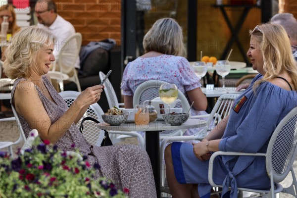 Two woman are sitting in a café and talking in the relaxed atmosphere of Tallinn, Tallinn, Harju, Estonia
