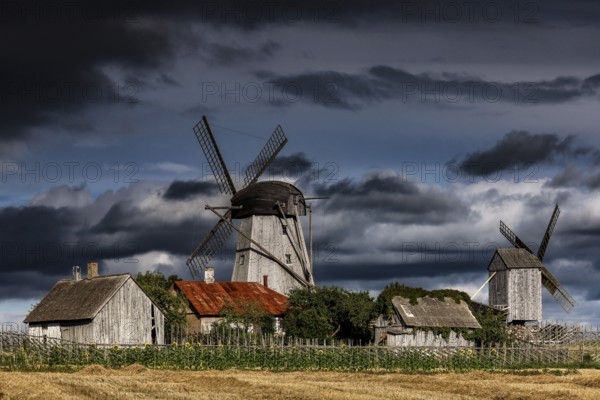 Traditional windmills against dramatic skies in Angla, Angla, Saaremaa, Estonia