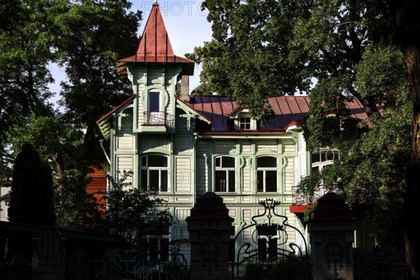 Classic wooden house with tower surrounded by dense forest, Tallinn, Estonia