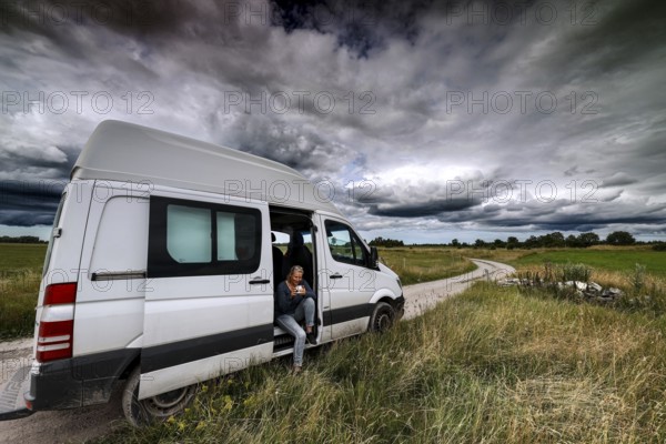 Transporter on a dirt road in Vilsandi National Park under dramatic clouds, Vilsandi National Park, Saaremaa, Estonia