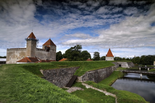 Historic Episcopal Castle of Arensburg with distinctive towers and moat in the foreground, Kuressaare, Saaremaa, Estonia