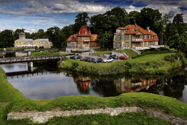 Historic buildings and hotel Ekesparre on the moat with picturesque reflection in the water, Kuressaare, Saaremaa, Estonia
