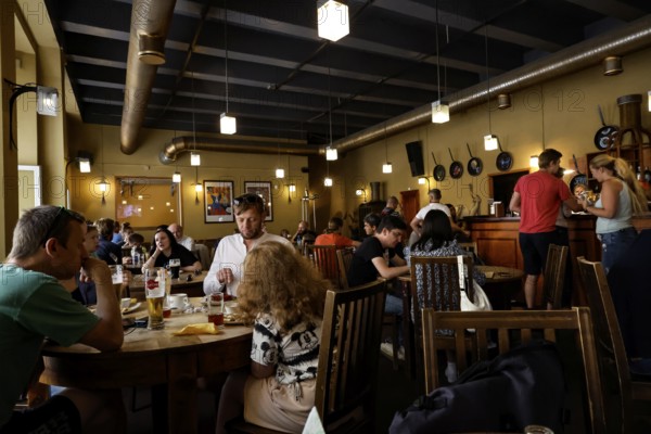 Cosy restaurant in Old Tallinn with guests dining and entertaining, Tallinn, Harju, Estonia