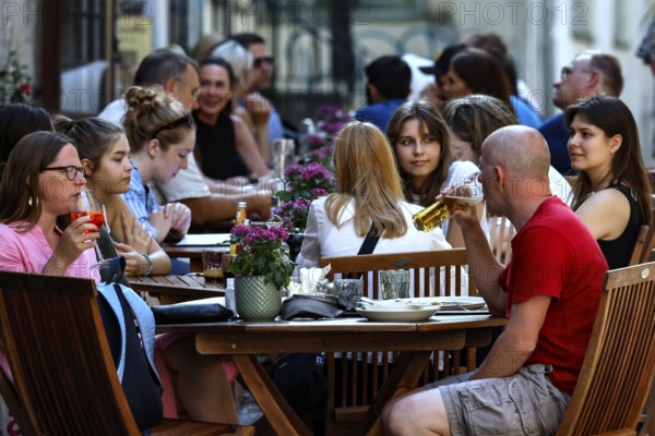 Guests enjoy dinner outdoors at a cozy restaurant in Old Town, Tallinn, Harju, Estonia
