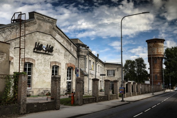 Historic factory buildings under cloudy sky in Telliskivi Creative Campus, Tallinn, Kelmiküla, Estonia