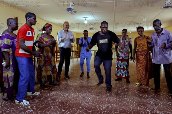 Dance therapy at CI Korhogo with a group of people in motion, Korhogo, CI, Côte d'Ivoire