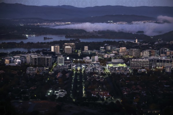 Nighttime view from Mount Ainslie Lookout of Canberra's illuminated CBD at dusk, Canberra, Australian Capital Territory, Australia