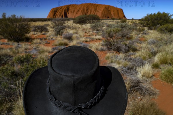 Black hat against the monumental Ayers Rock backdrop in the Australian Outback, Uluru, Northern Territory, Australia