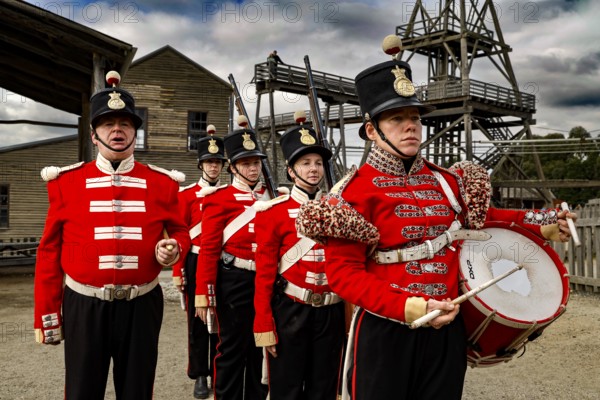 Soldiers wearing historic red uniforms in front of a gold mine in Sovereign Hill, Ballarat, Victoria, Australia
