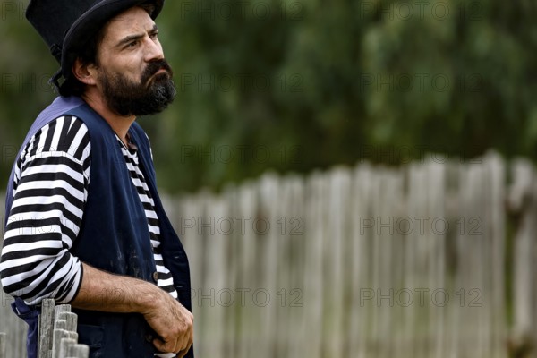 A performer wearing traditional dress looks seriously into the distance, Ballarat, Australia