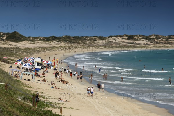 Busy cable beach with lots of visitors under blue skies, Broome, Western Australia, Australia