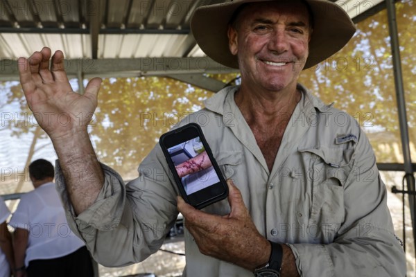 Man proudly shows the scar from a crocodile attack on his arm, Adelaide River, Northern Territory, Australia