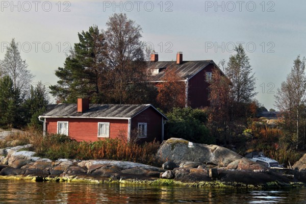 Wooden house on an island near Helsinki, surrounded by autumn-colored trees, Helsinki, Finland