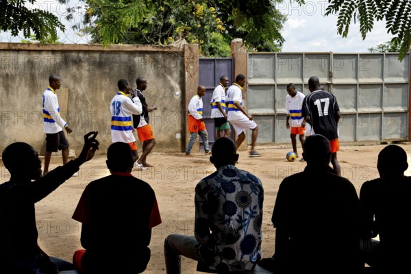 Men playing soccer in the courtyard of Saint Camille men's psychiatry, Bouaké, Côte d'Ivoire