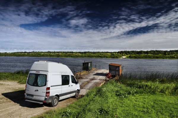 Sprinter on a ferry crossing the Daugava on a cloudy day, Dunava, Latvia