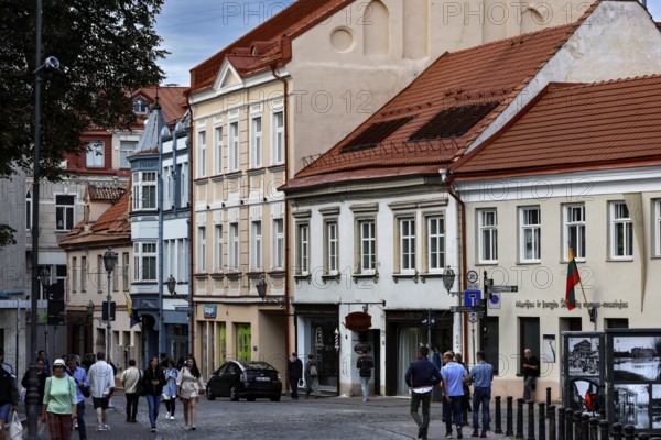 Architecture of an old town street with pedestrians in Vilnius under cloudy sky, Vilnius, Vilnius County, Lithuania