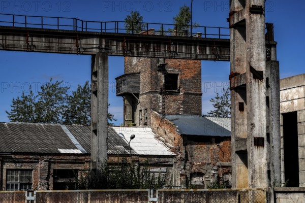 Former factory site with brick structures and blue sky, Daugavpils, Latvia