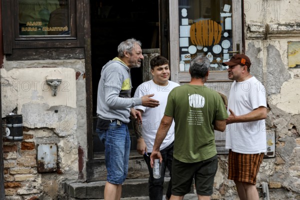 Group of men talking friendly in front of an old building in Uzupis, Vilnius, Vilnius County, Lithuania