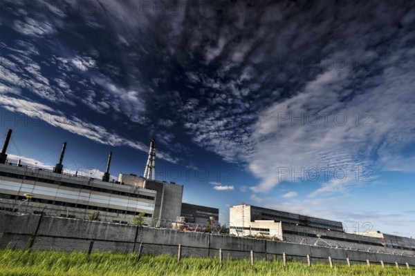 Wide angle view of abandoned power plant under dramatic sky, Visaginas, Lithuania