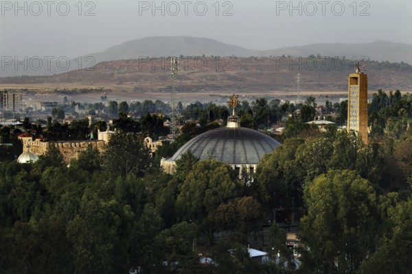 View of St. Mary's Cathedral in Axum from Yeha Hotel with surrounding greenery and mountains in the background, Axum, Ethiopia
