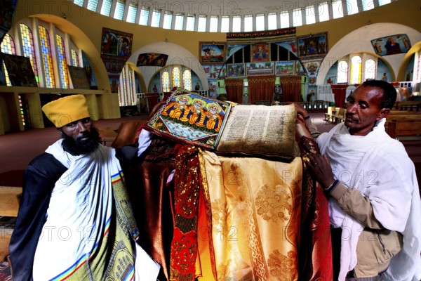 Priests present an opened Bible at St. Mary's Cathedral in Axum during a ceremony, Axum, Tigray, Ethiopia