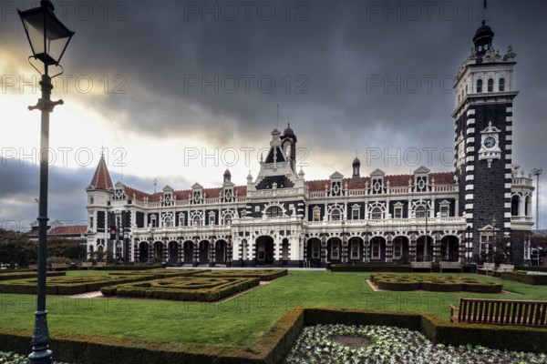 Historic Dunedin railway station with well-kept gardens and dramatic skies, Dunedin, null, New Zealand