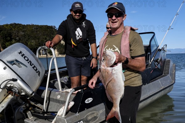 Anglers with Red Snapper on a boat near Adele Island, Adele Island, Abel Tasman National Park, New Zealand